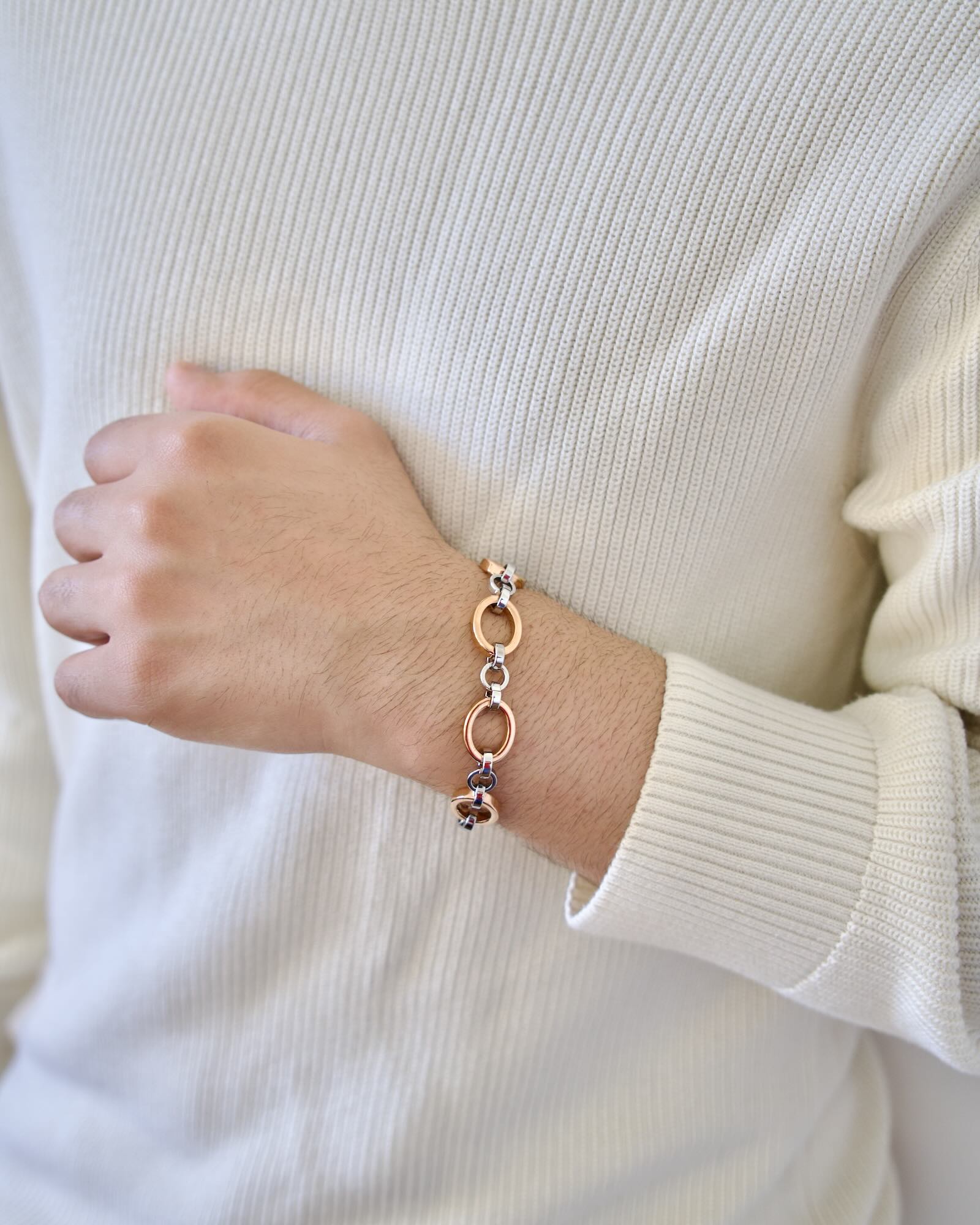 Men's wrist wearing Meridian Chain Bracelet in Frosty Rose, 18K rose & white gold PVD stainless steel - wrist raised