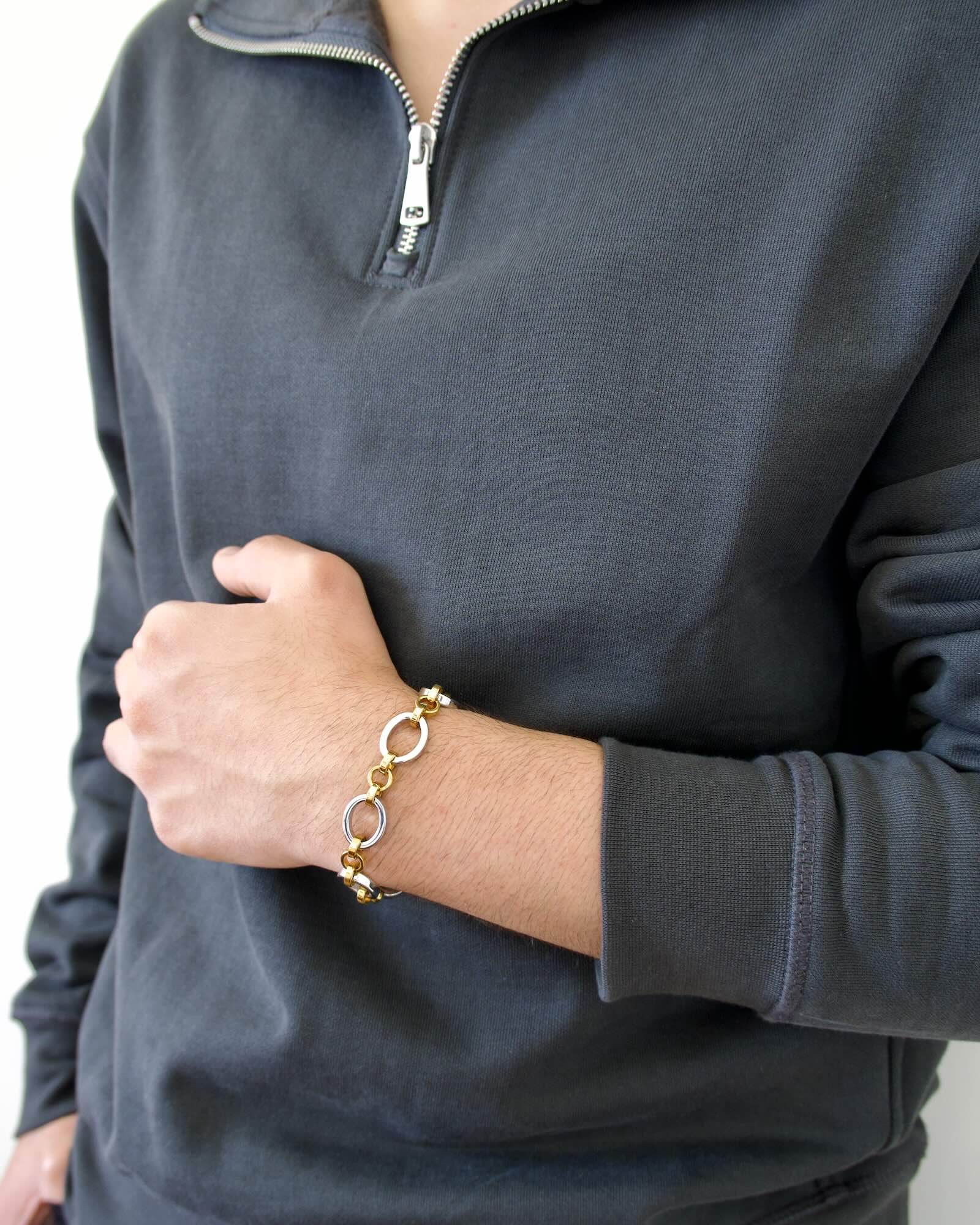 Men's wrist wearing Meridian Chain Bracelet in Twilight, 18K white & yellow gold PVD stainless steel - arm across torso